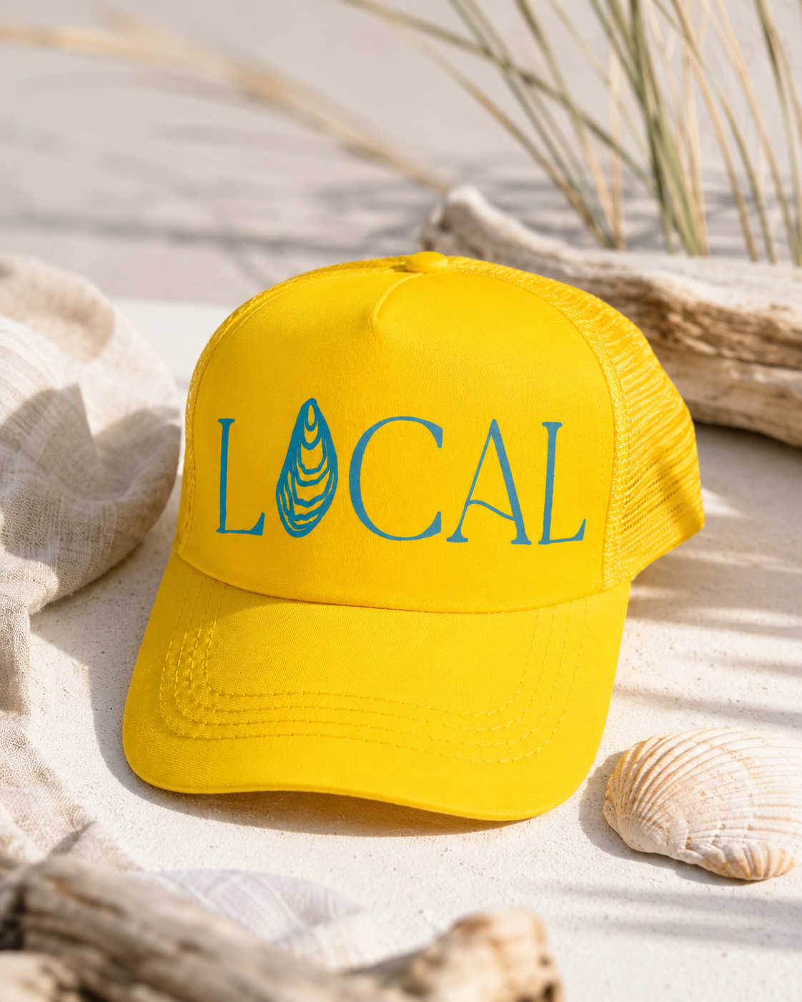 Yellow and blue Local Coastal trucker hat styled for the about section